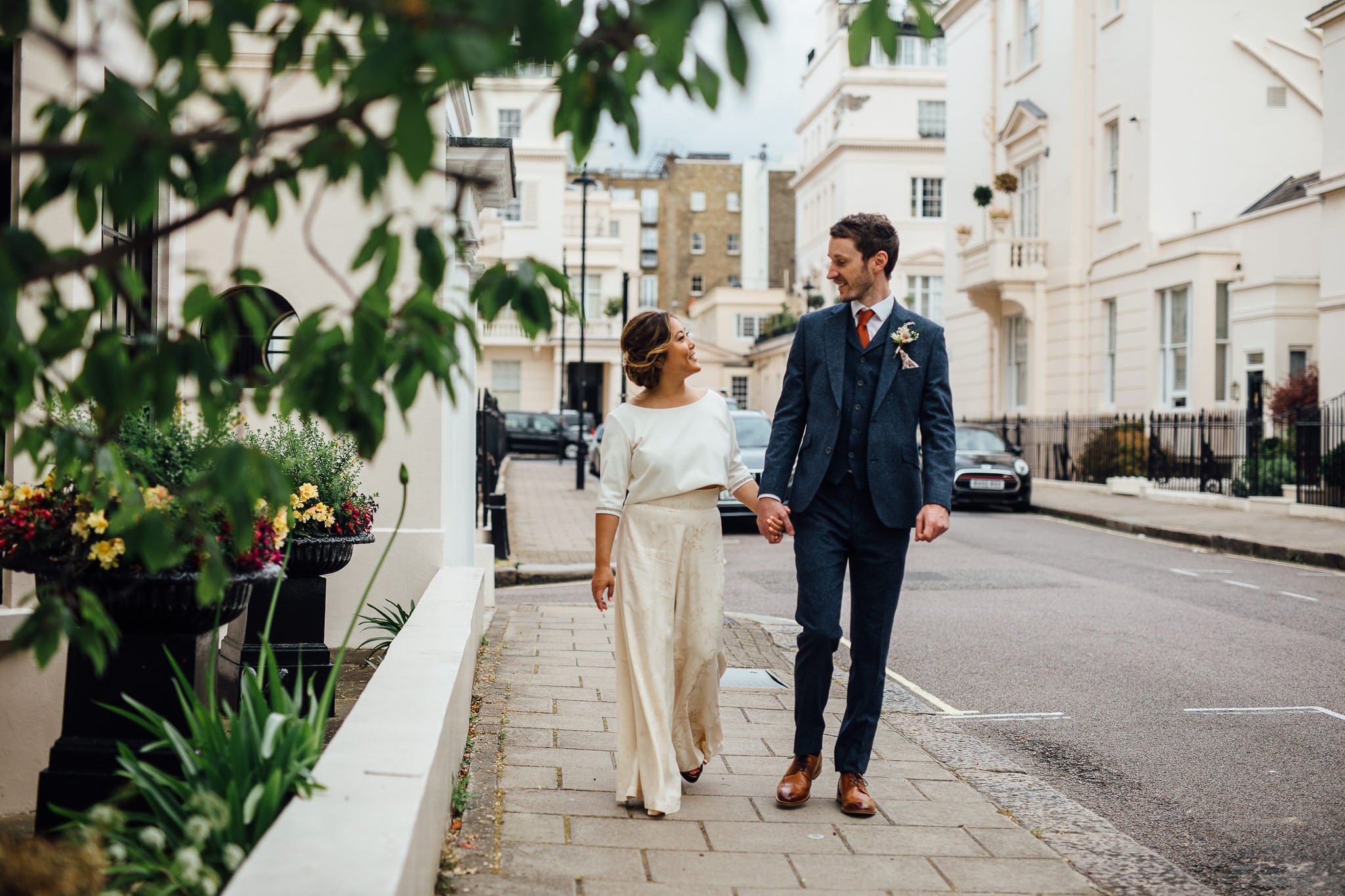  Bride and Groom holding hands near  Islington Town Hall 