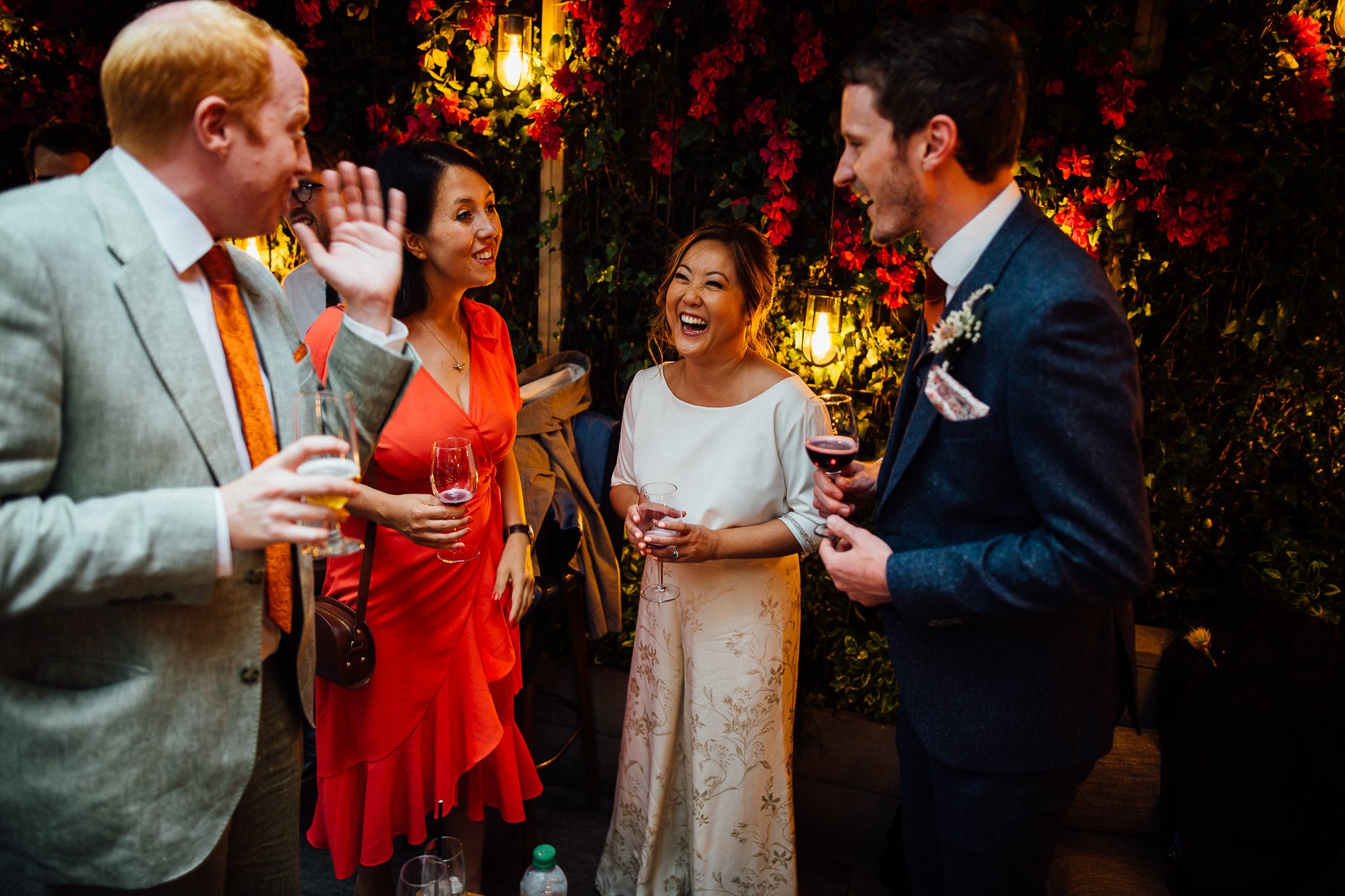  Bride laughing whilst talking to guests 
