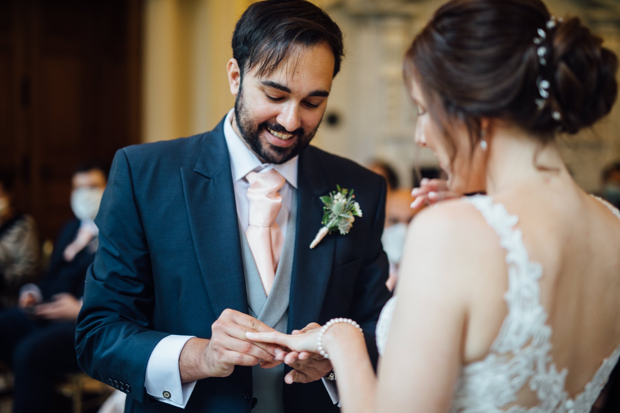  Groom places ring on the finger of his bride at Orleans House Gallery 