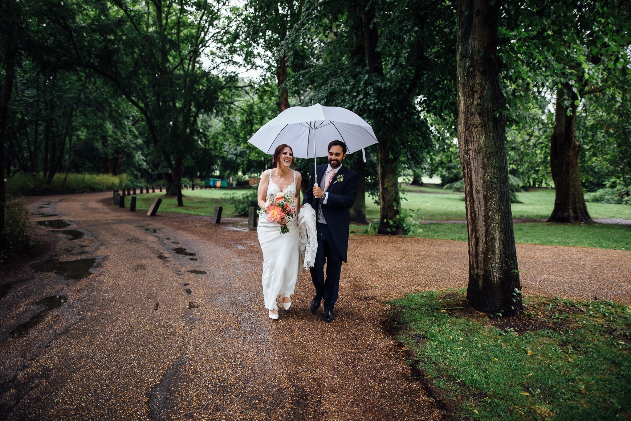  Bride and Groom go for a walk in the rain after their wedding ceremony at  Orleans House Gallery 