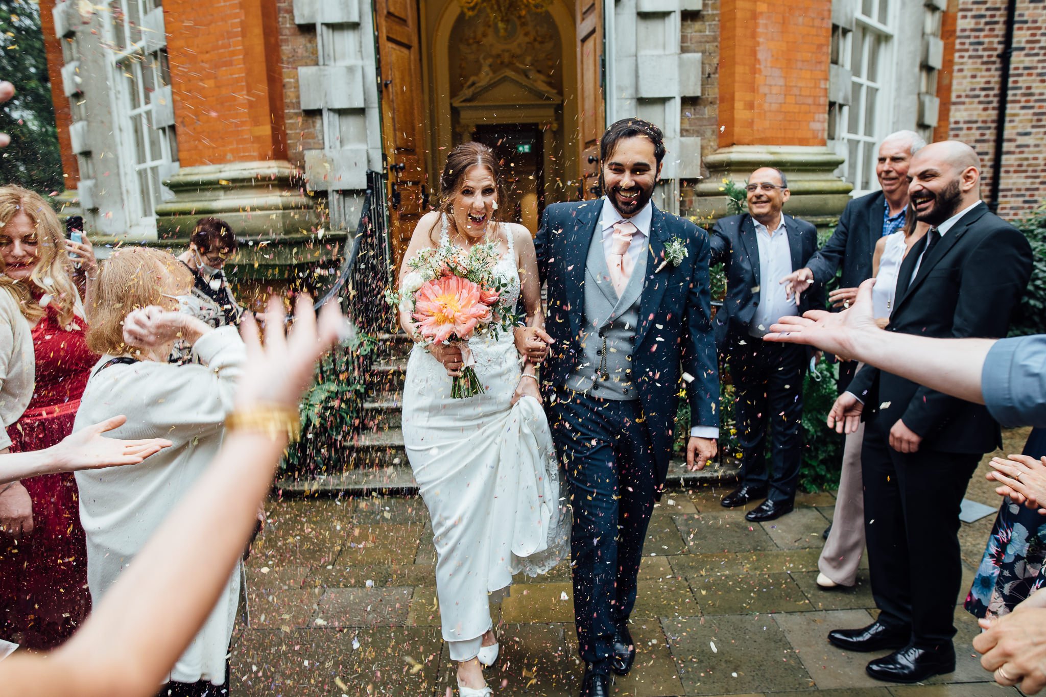  Bride and Groom have confetti thrown at them after their wedding ceremony at  Orleans House Gallery 