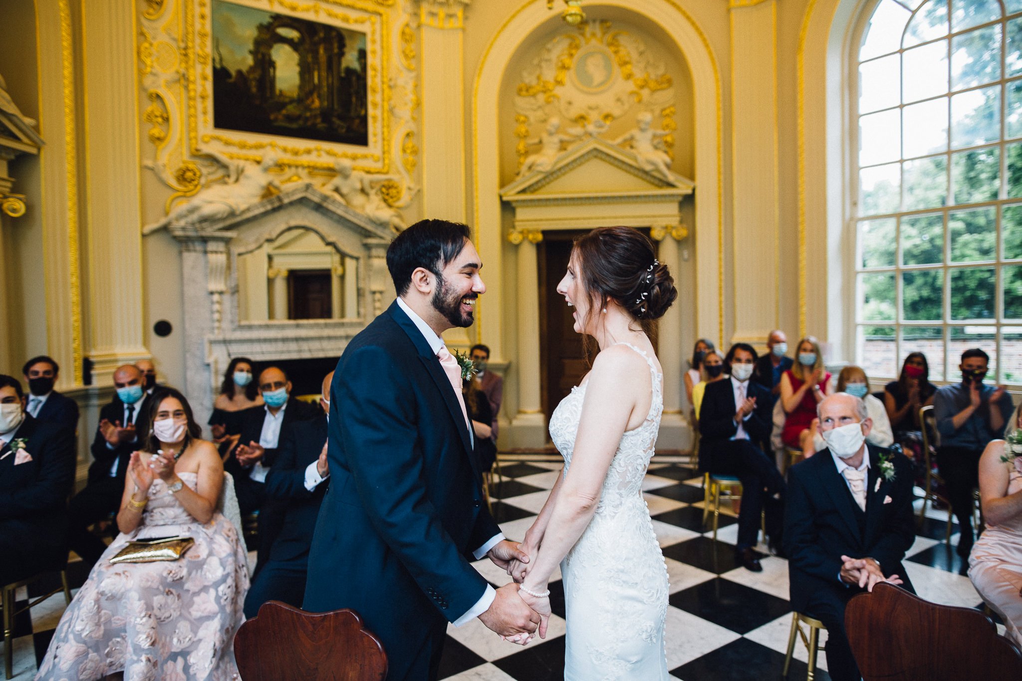  Bride and Groom laughing after they have been married in the Octogan Room at  Orleans House Gallery 