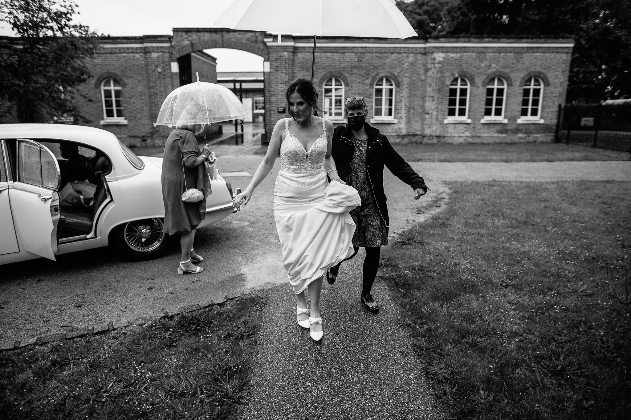  Bride runs from the wedding car in the rain at  Orleans House Gallery 