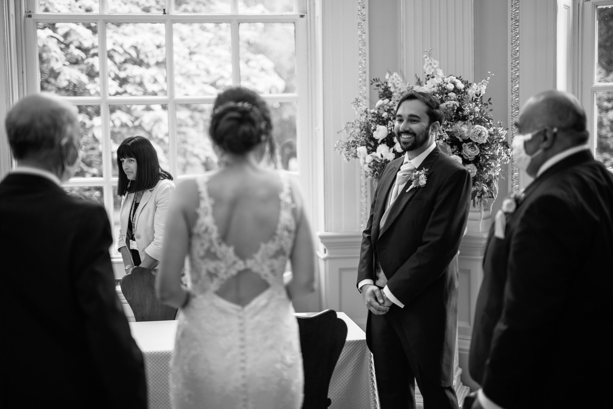  Groom smiling as the bride walks down the aisle at  Orleans House Gallery 