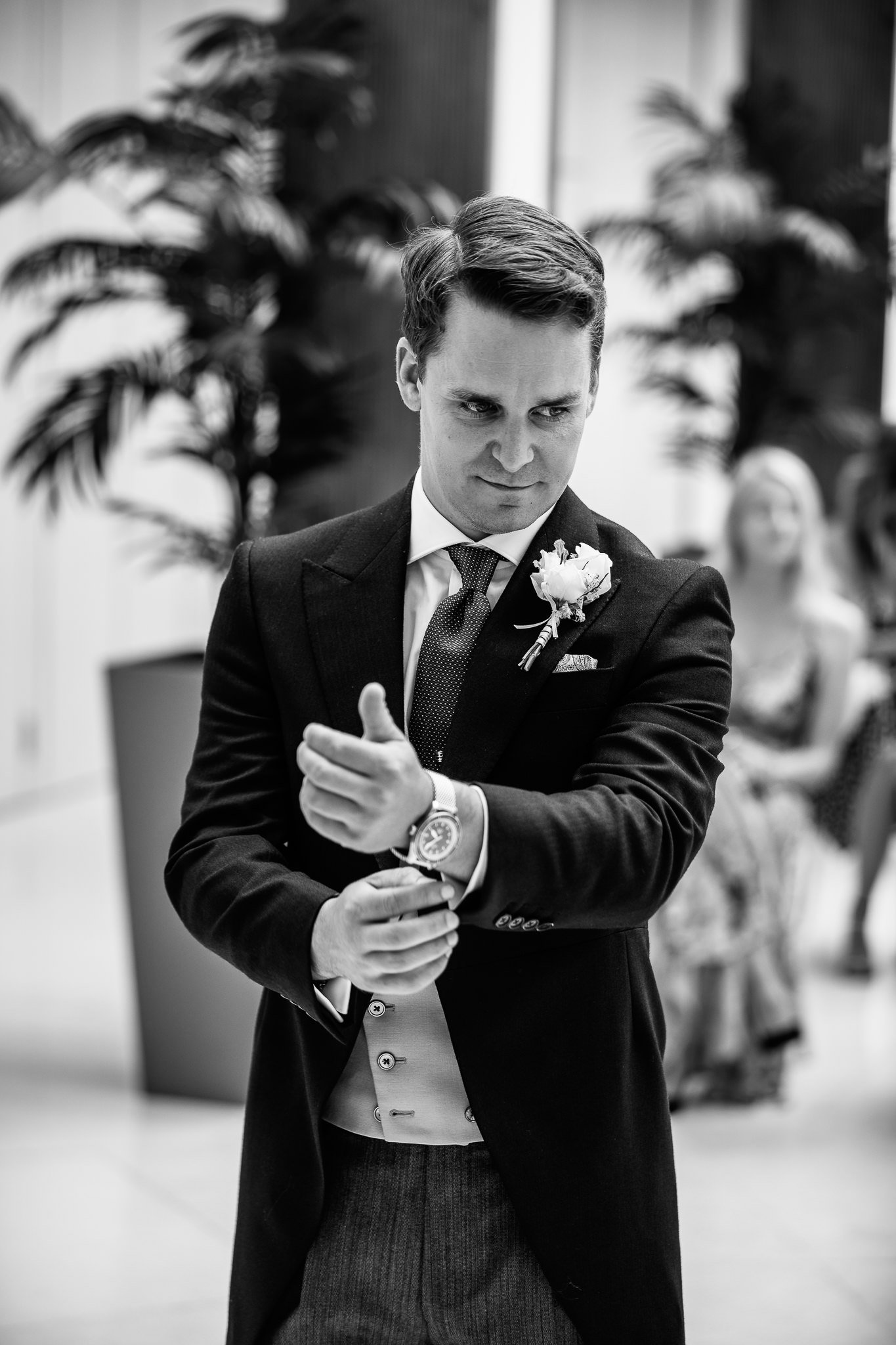  Groom adjusts his cufflinks before the wedding ceremony at Hurlingham Club 