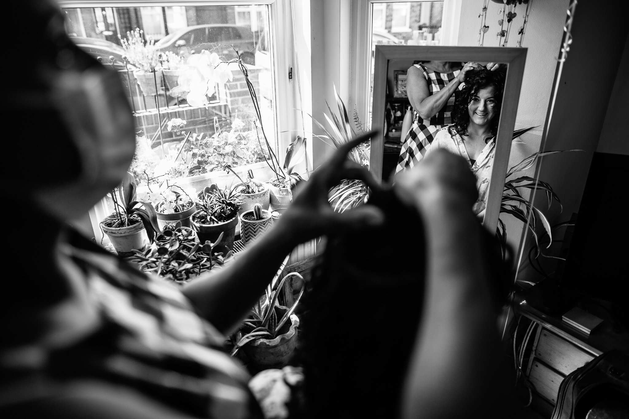  Bride looking in the mirror as she prepares for her wedding day 