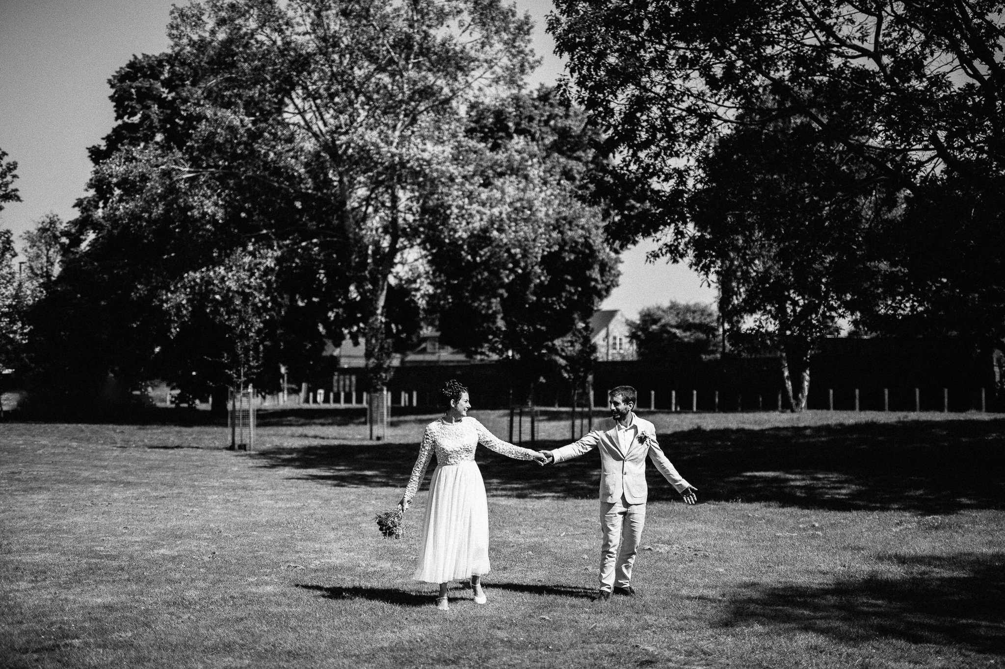  Bride and Groom holding hands in a park 