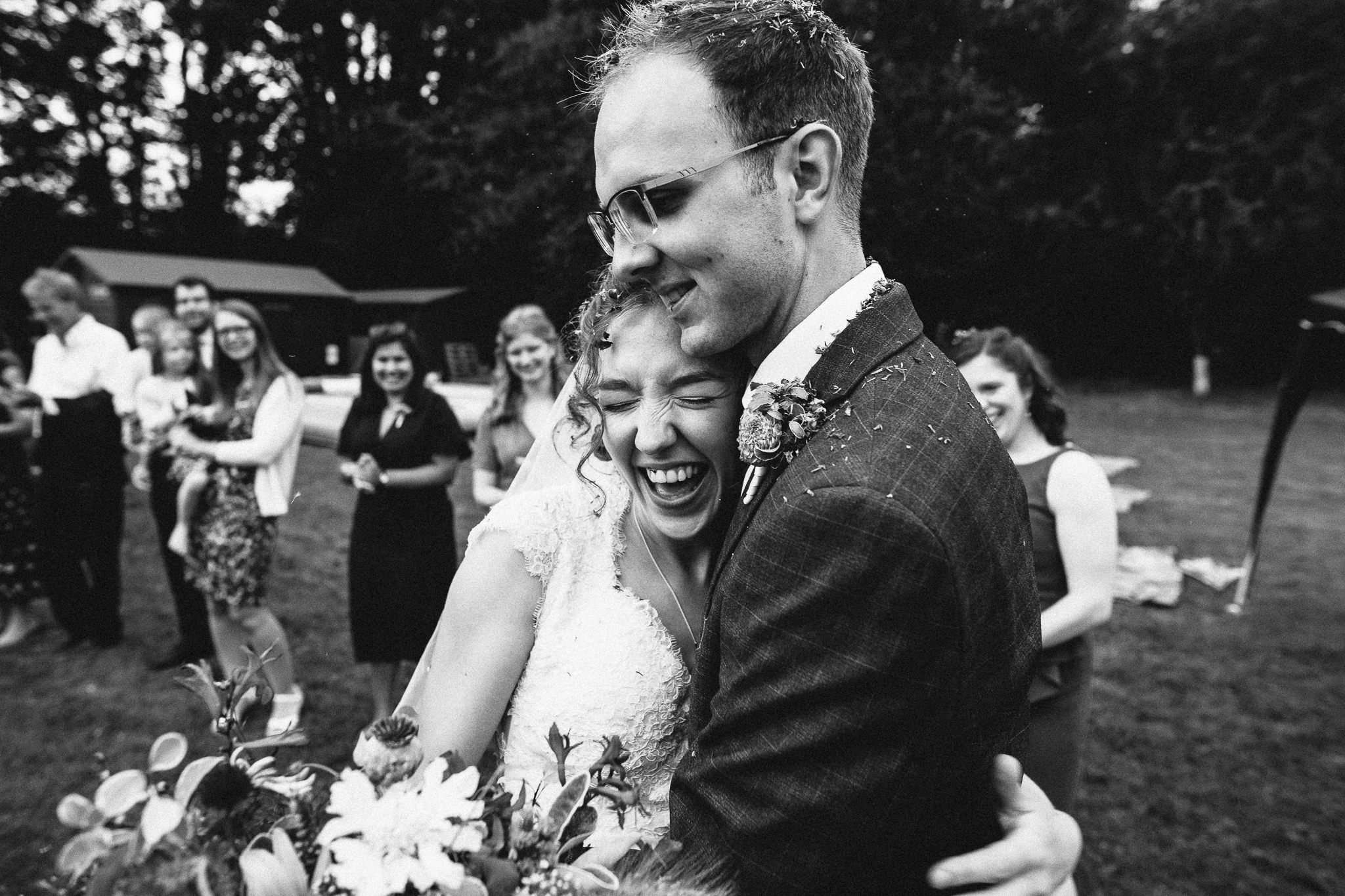  Bride and Groom hug after confetti at Harpsden Village Hall 