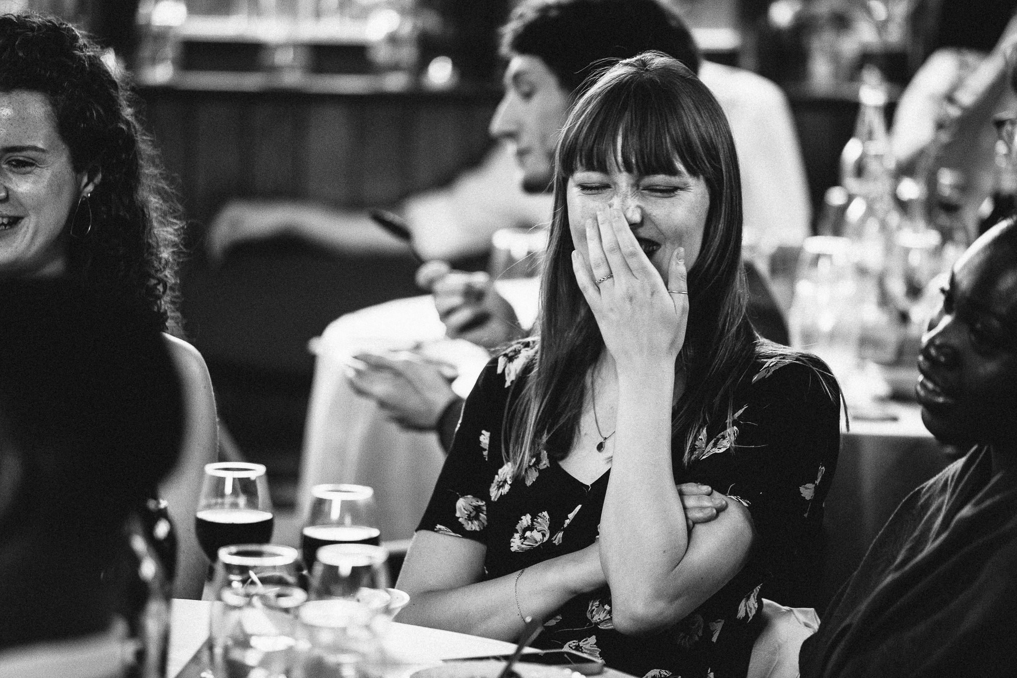  Wedding guest laughing during the speeches at Harpsden Village Hall 