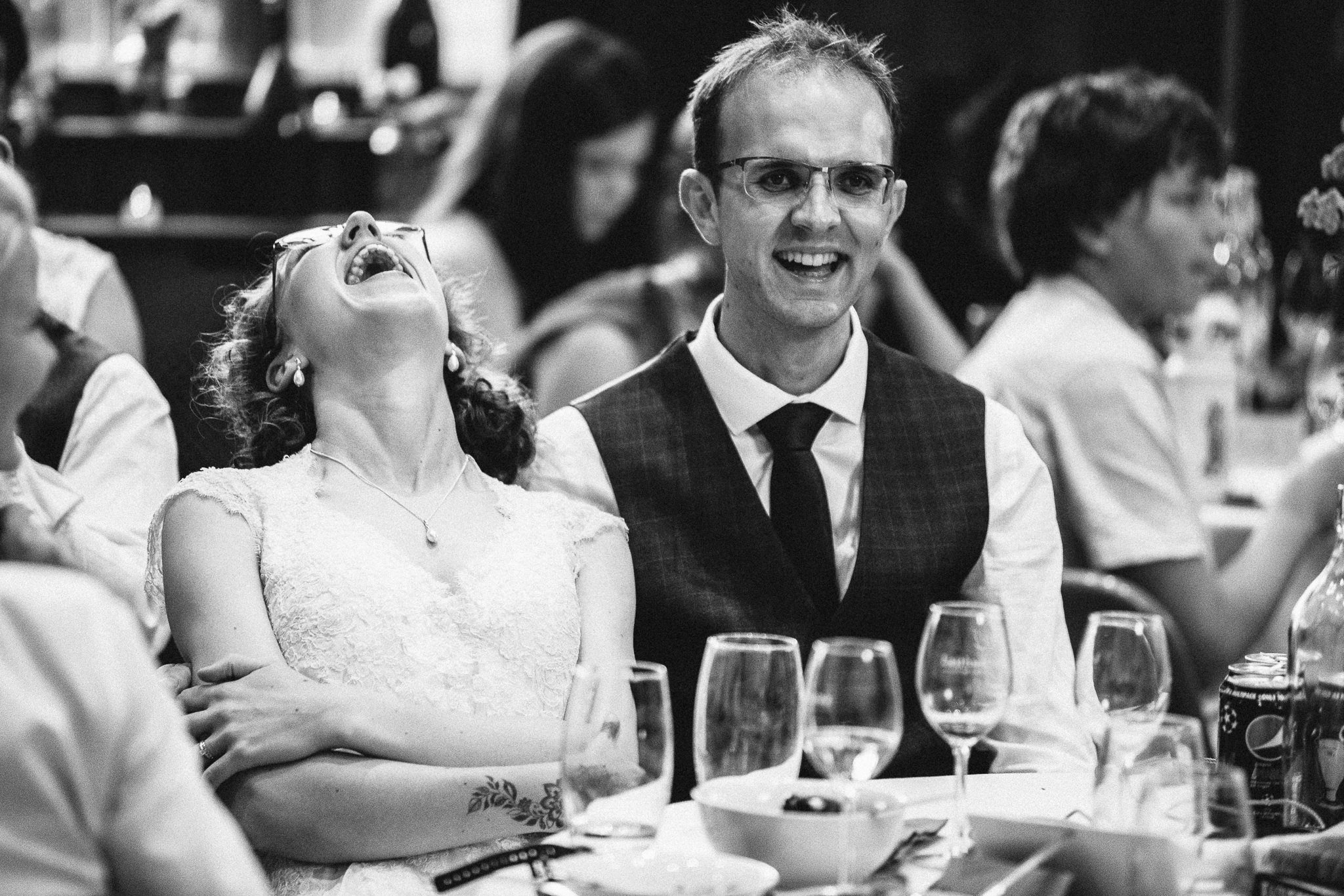  Bride laughing with her head back at Harpsden Village Hall 