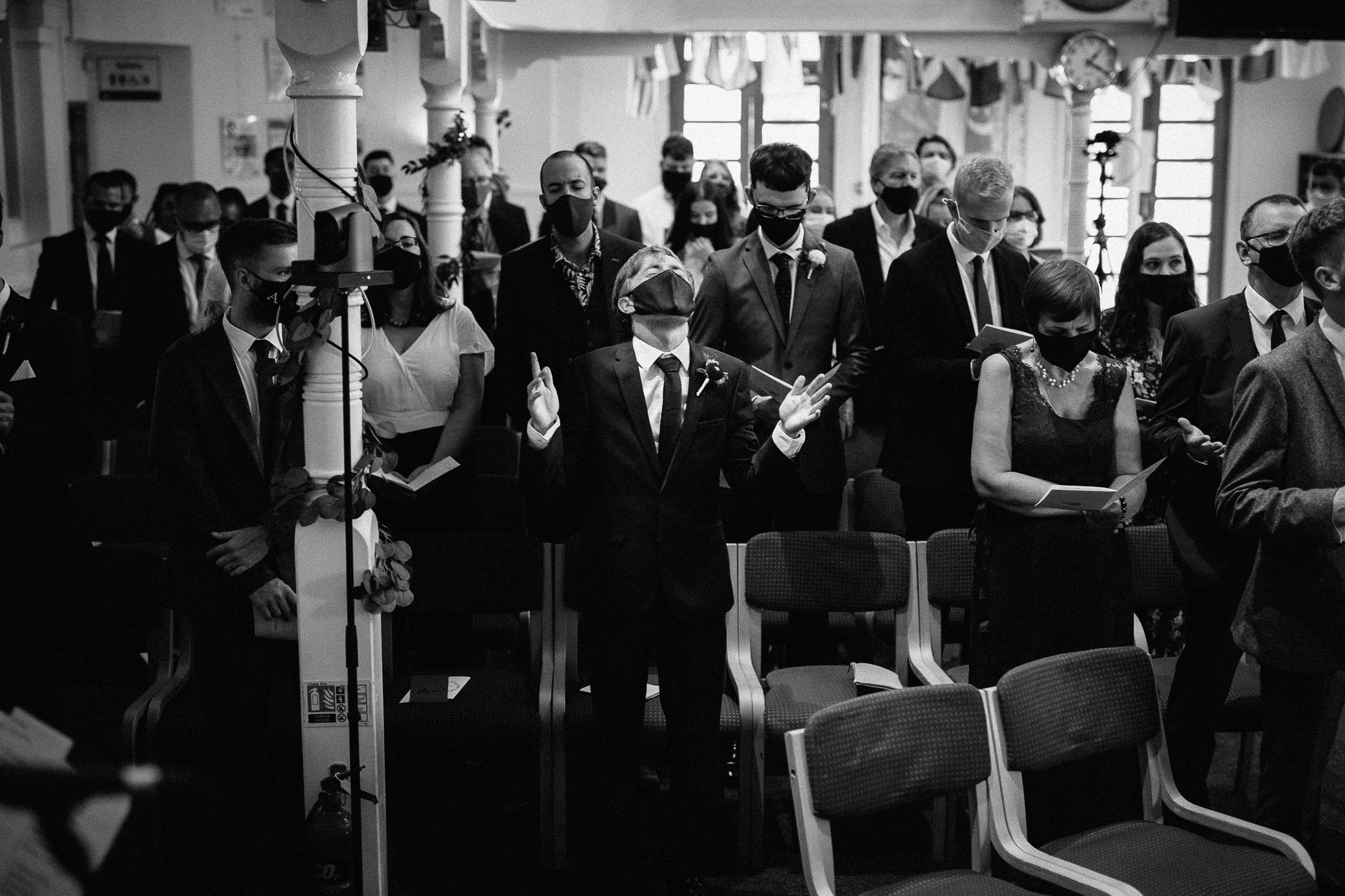  Wedding guest praying at Wycliffe Baptist Church in Reading 