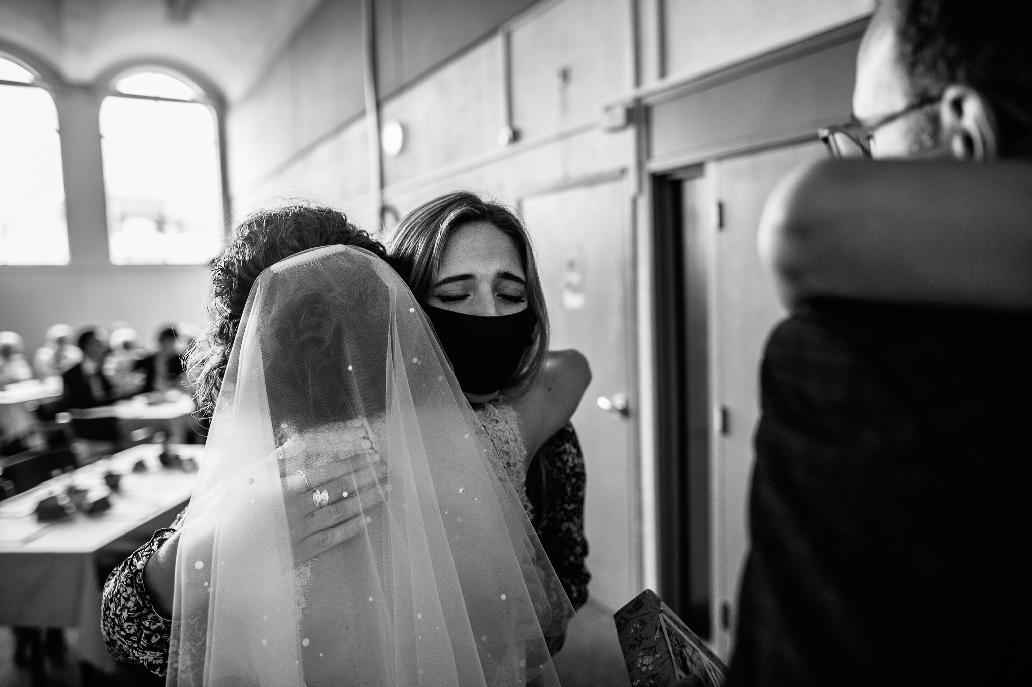  Wedding guest hugs the bride with a facemask on at Wycliffe Baptist Church in Reading 