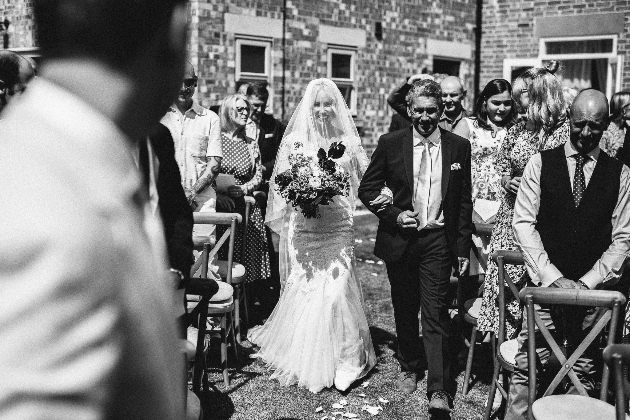  Bride walks up the aisle with her father 