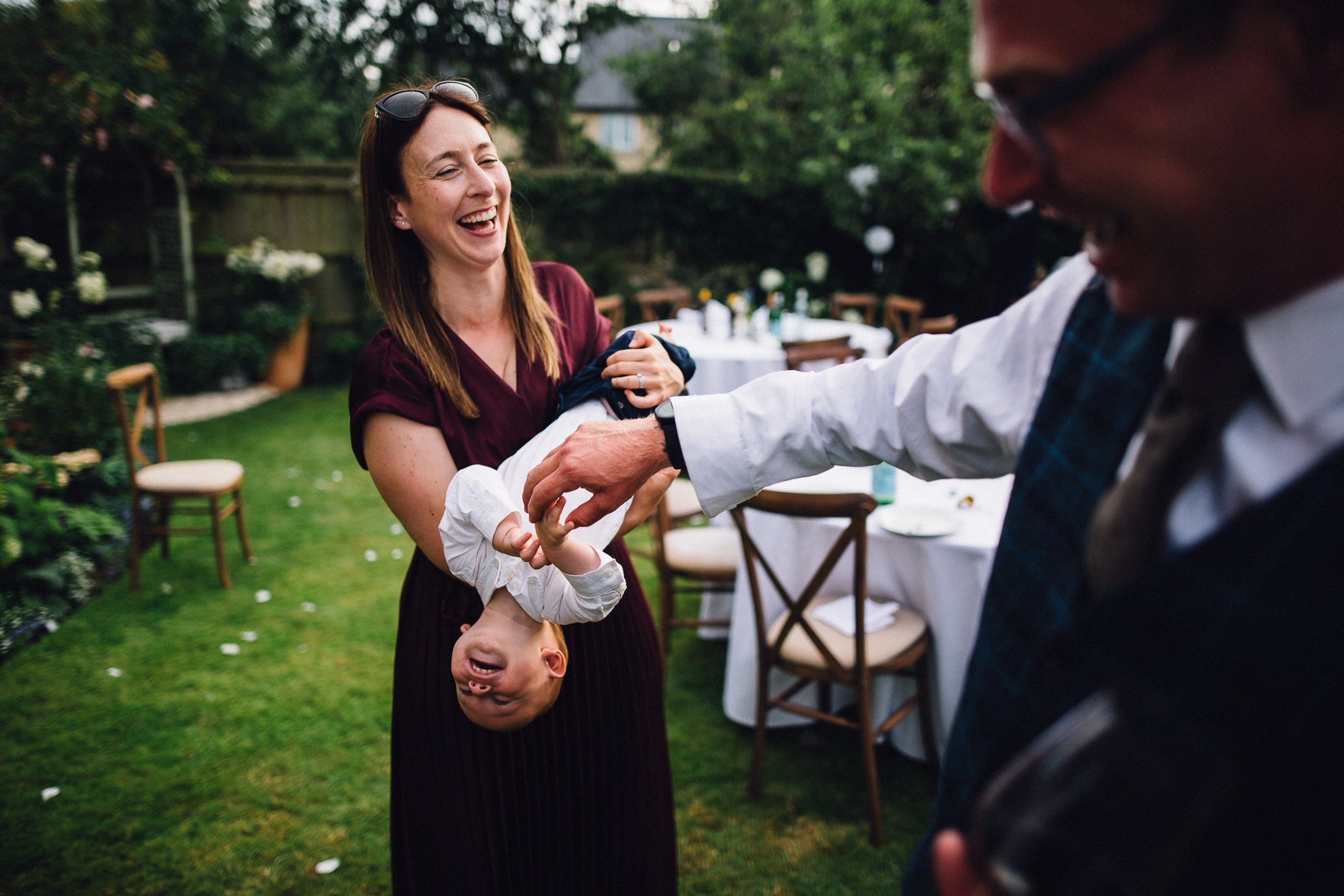  Wedding guest ticking a young boy as they all laugh 