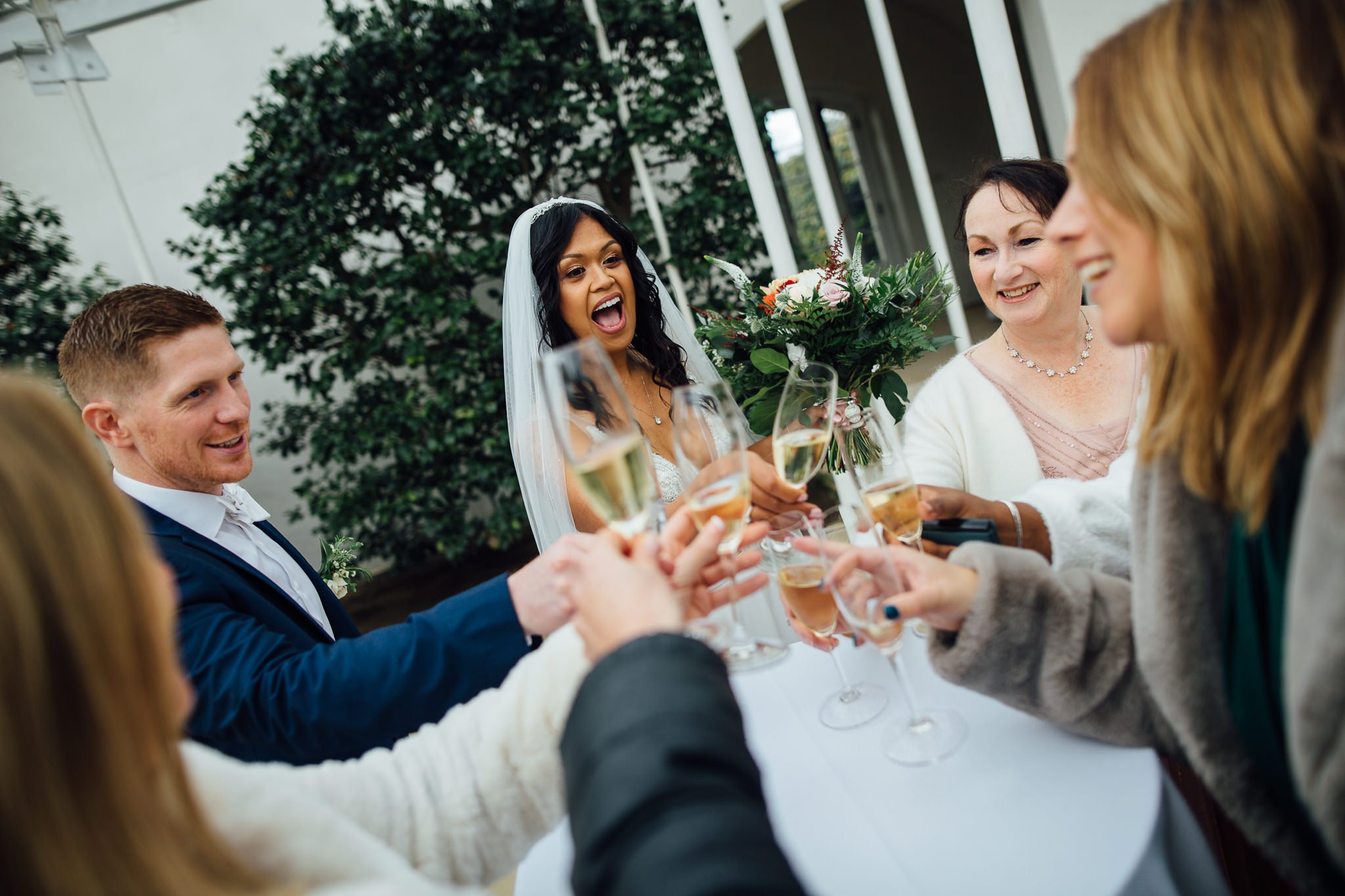  The Bride and Groom cheers with champagne at Chiswick House and Gardens 