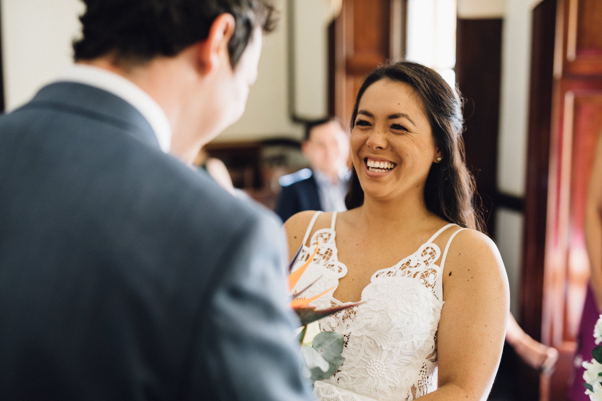  Bride smiling during the ceremony at The Mansion in Leatherhead 