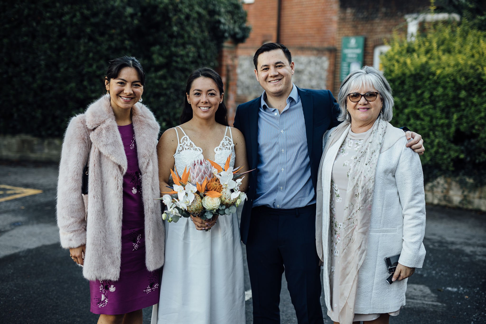  Bride poses for a group shot with her family 