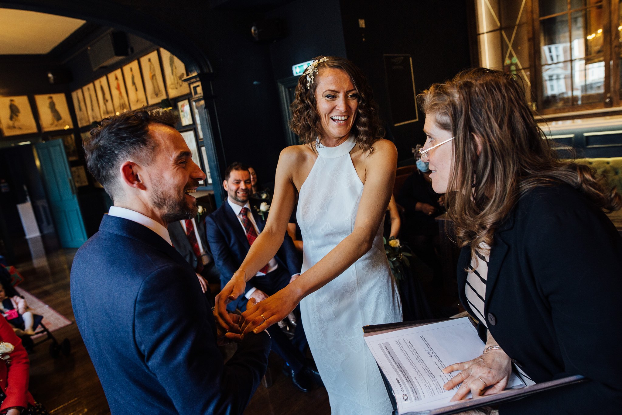  The Bride and Groom laughing during the ceremony at The Bull and Gate 