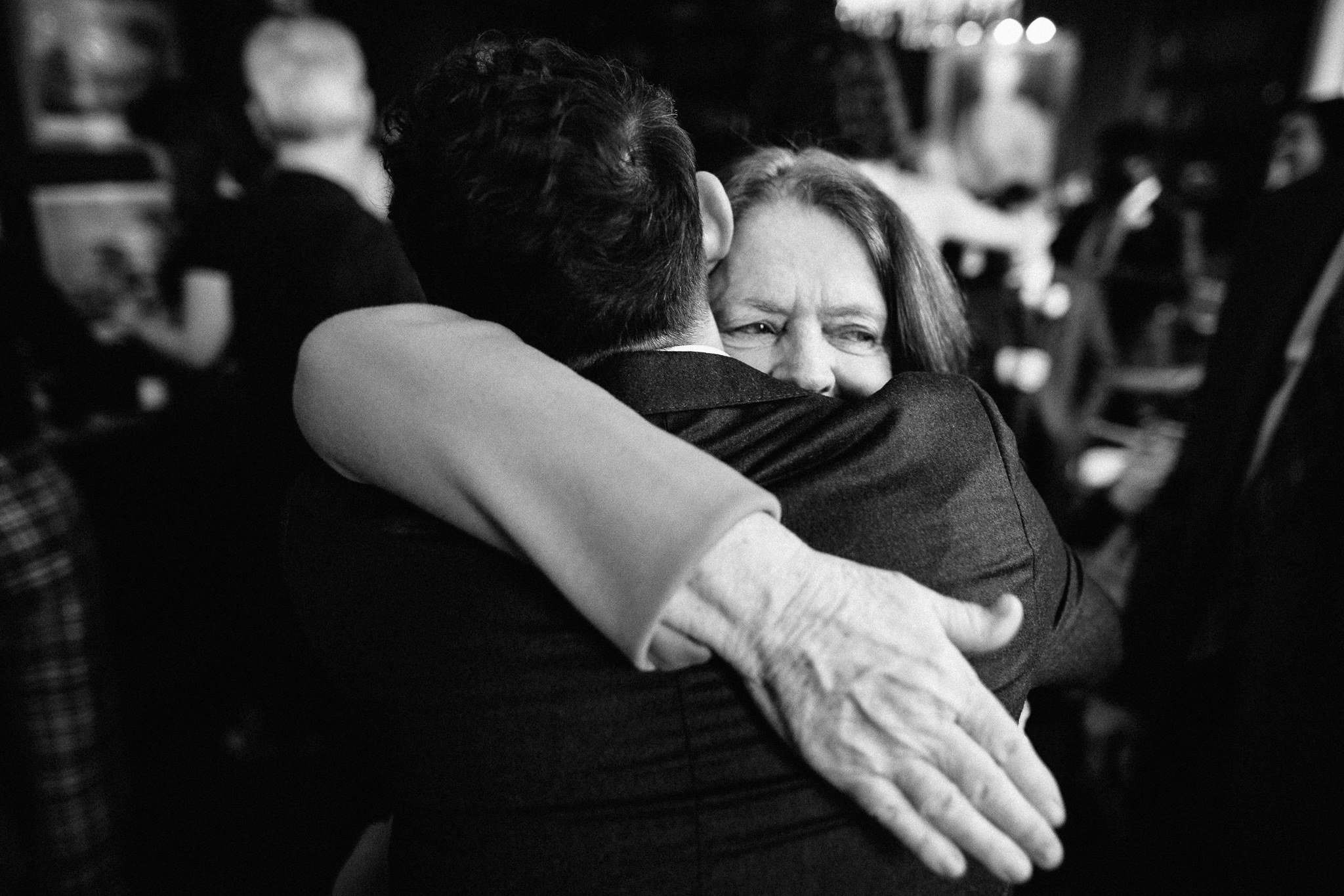  Mother of the Groom hugs her son 