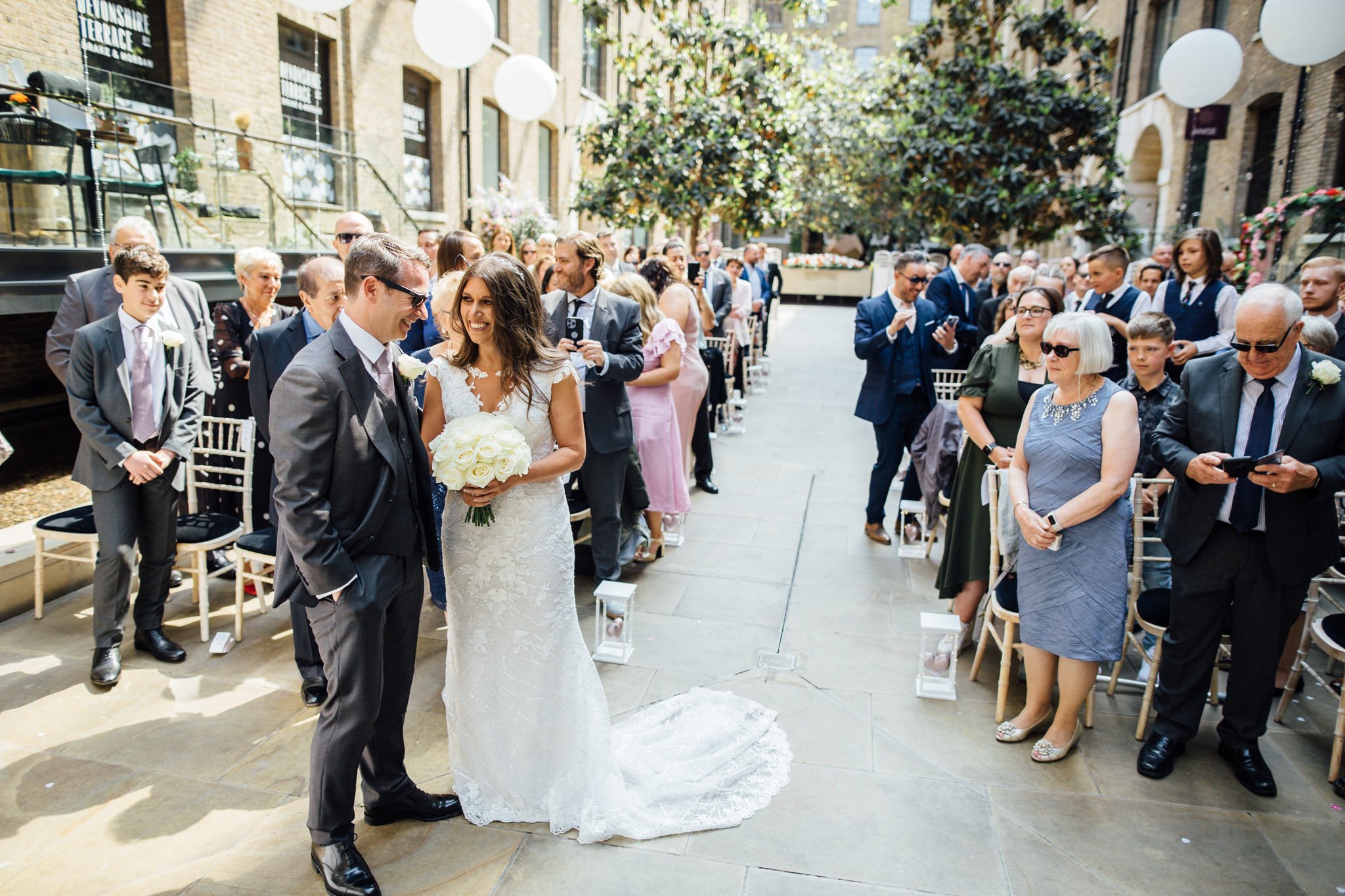  Bride and Groom and their guests during the ceremony at Devonshire Terrace 