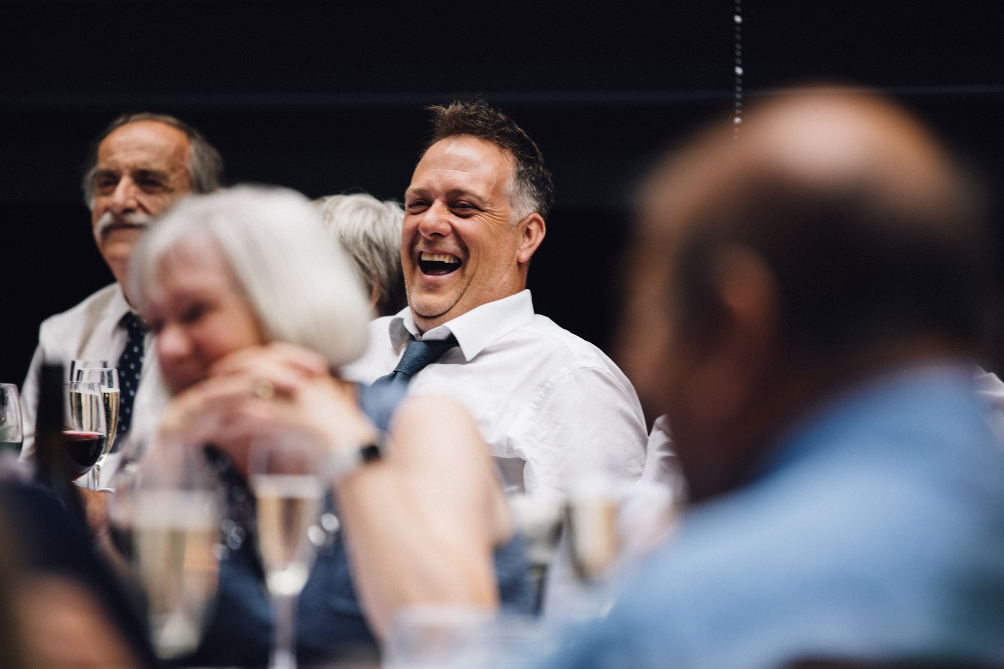  Wedding guest laughing during the speeches 