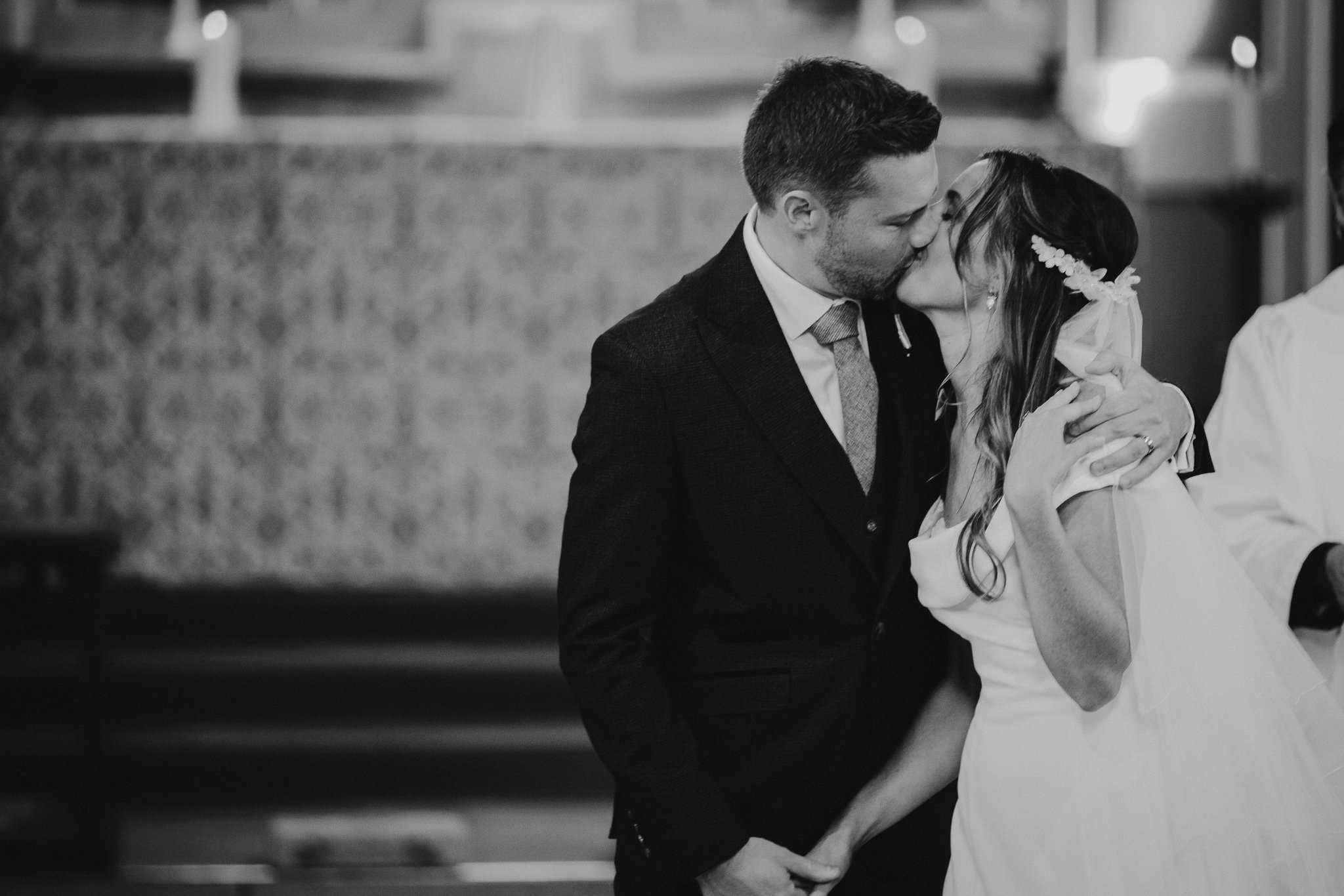  The Bride and Groom kiss in All Saints church Hampton 