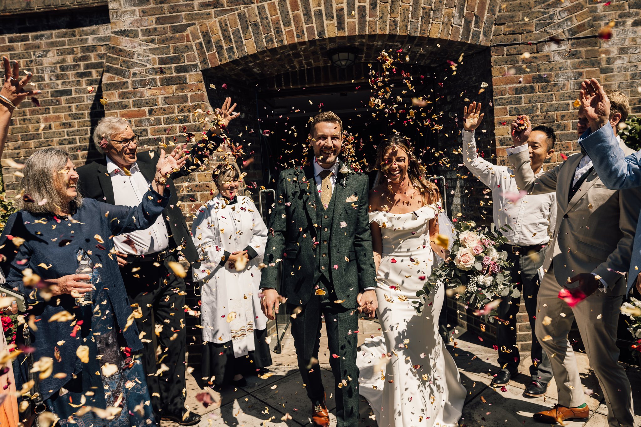  Bride and Groom have confetti thrown at them outside All Saints Church in Hampton 