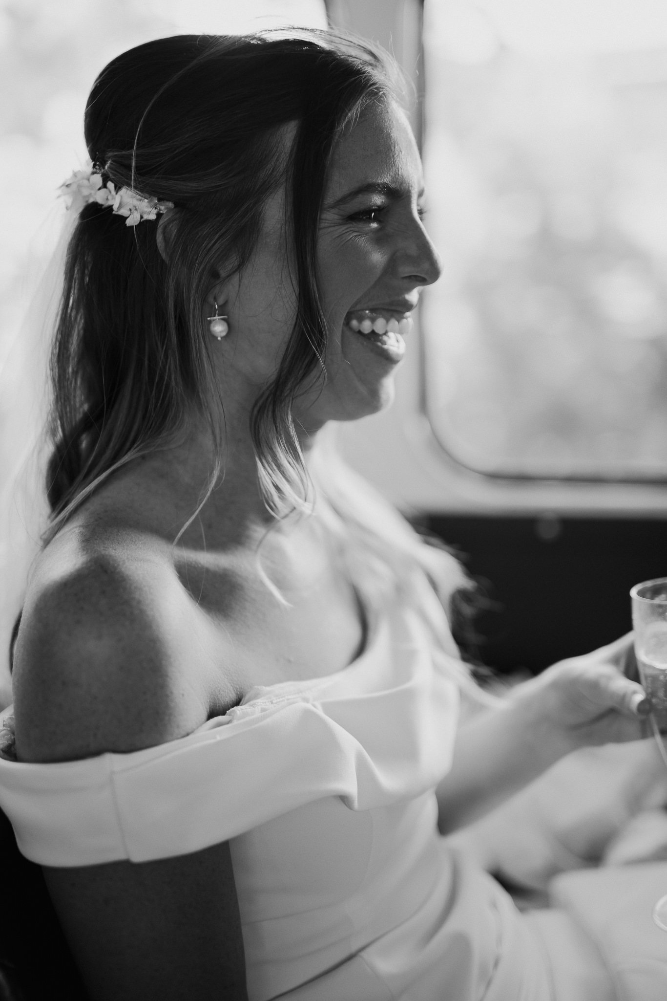  Bride laughing on the wedding bus 