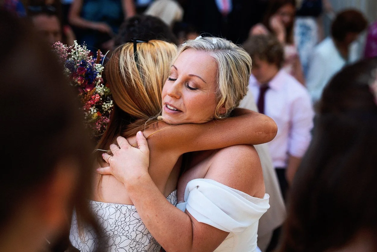 Bride hugging guest