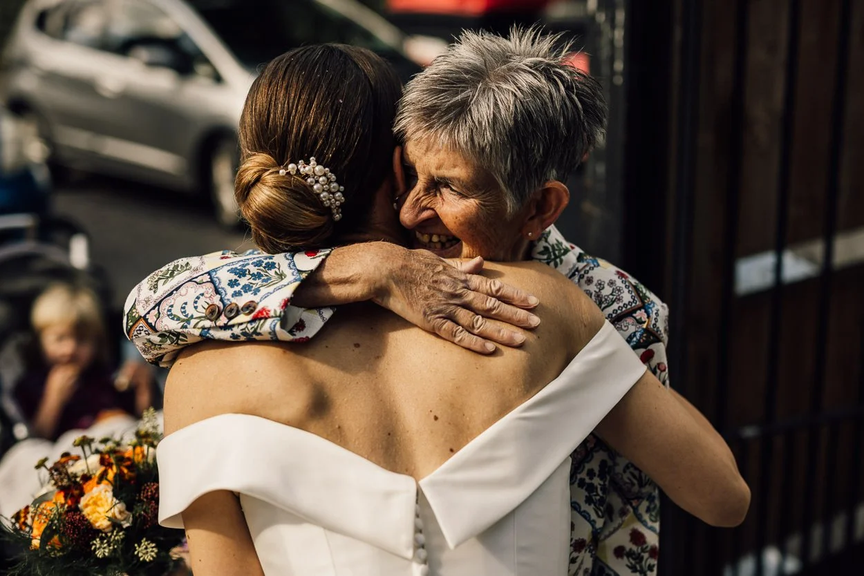 Wedding guest hugs the bride