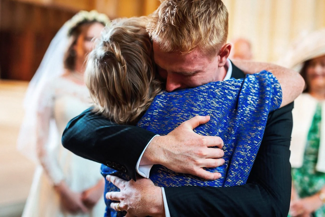 The groom hugs his mother