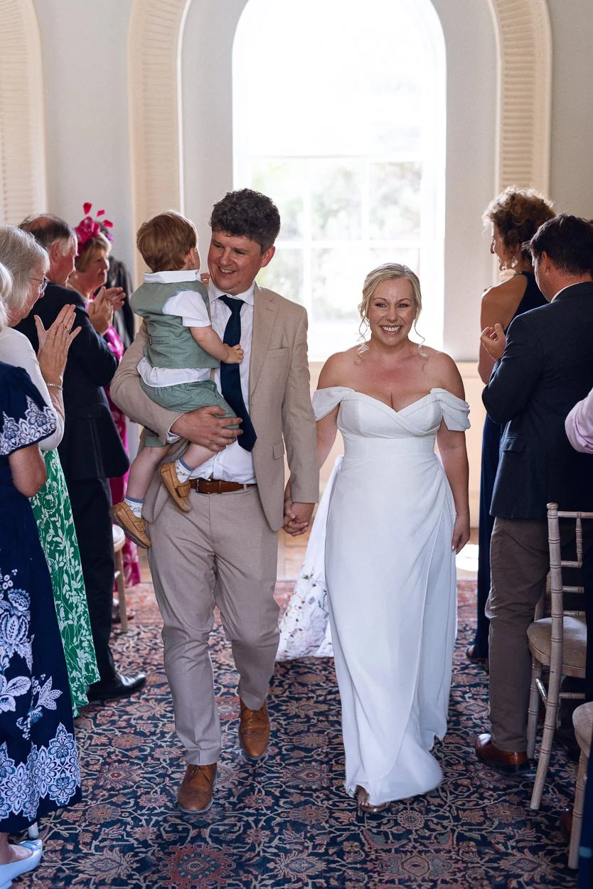 Bride and Groom walk down the aisle with their son