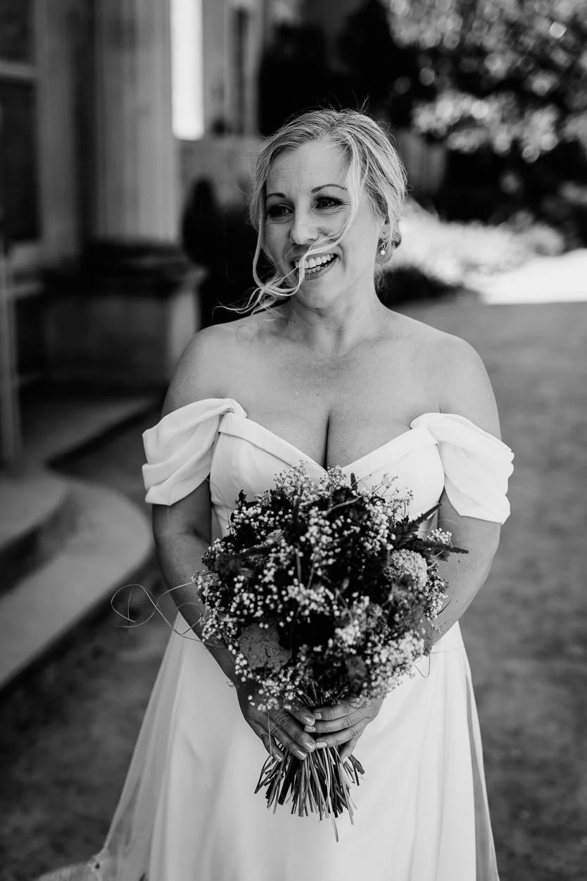 Bride laughing with her bouquet