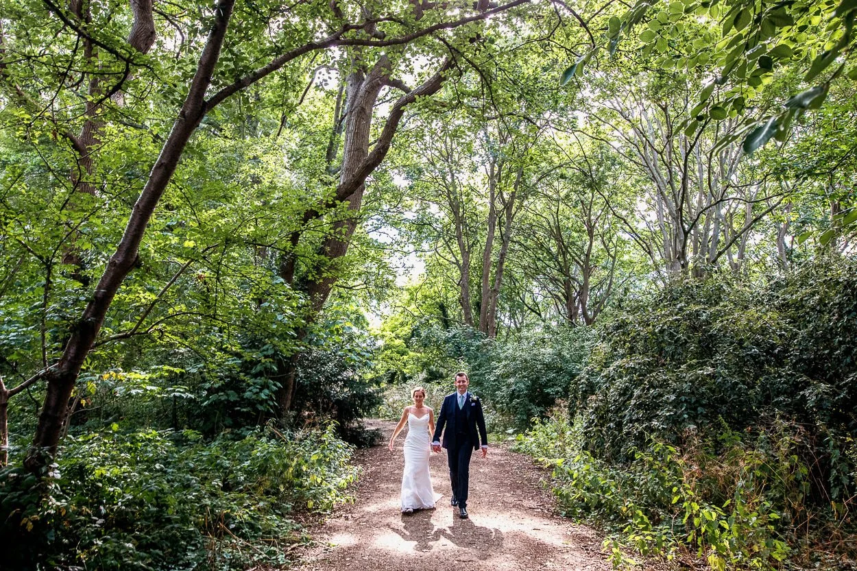 Bride and Groom walk through the grounds of Orleans House Gallery
