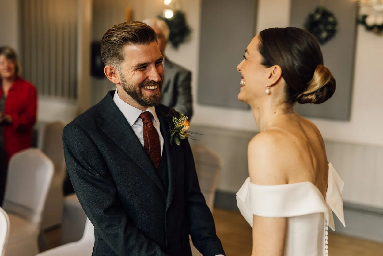 Bride and Groom smiling during the ceremony