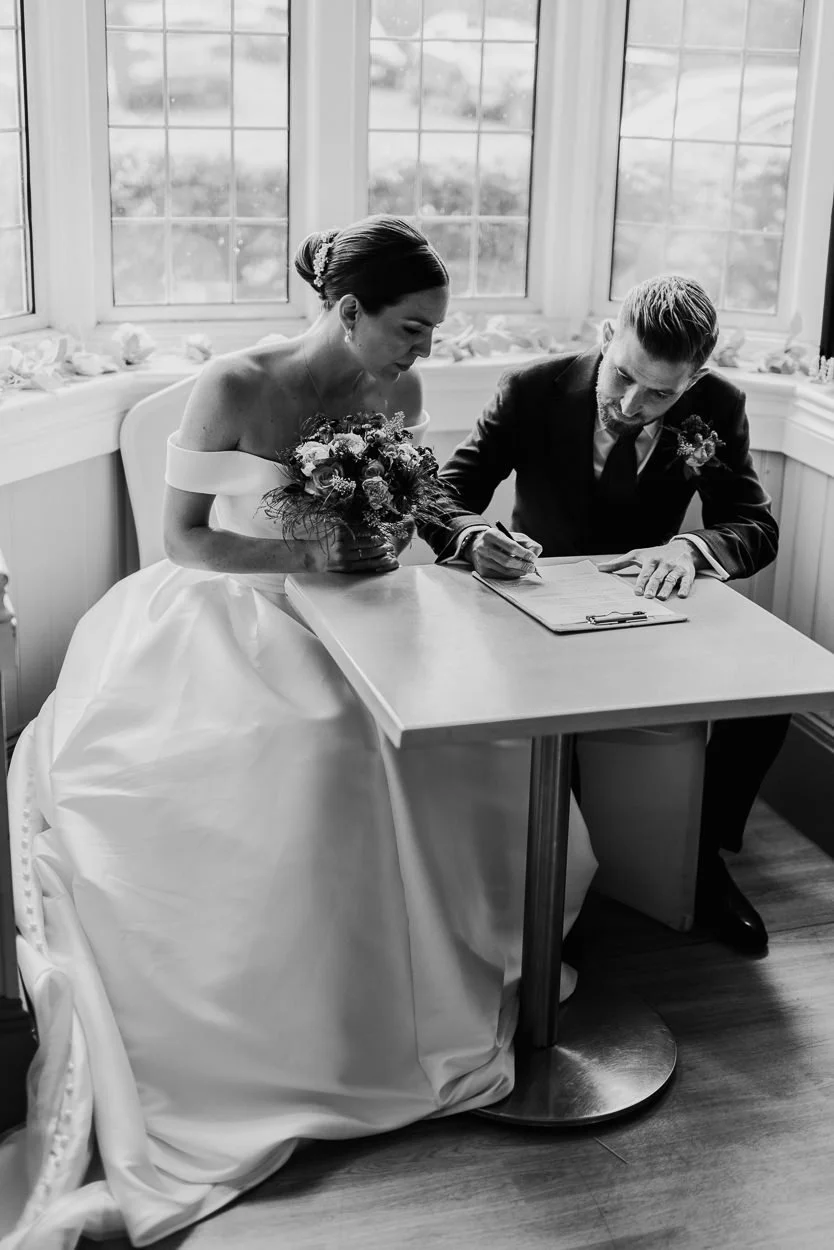 Bride and Groom signing the register after the ceremony