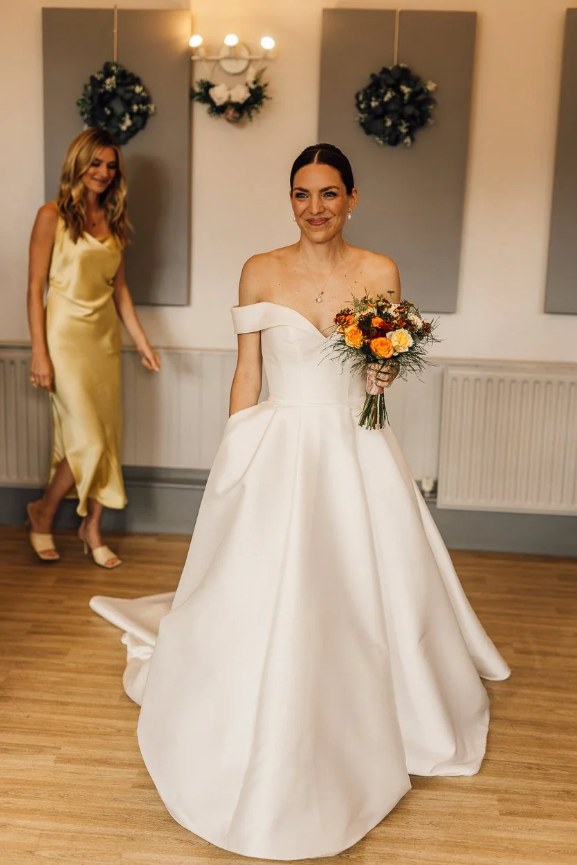 Bride walks down the aisle with her sister behind her