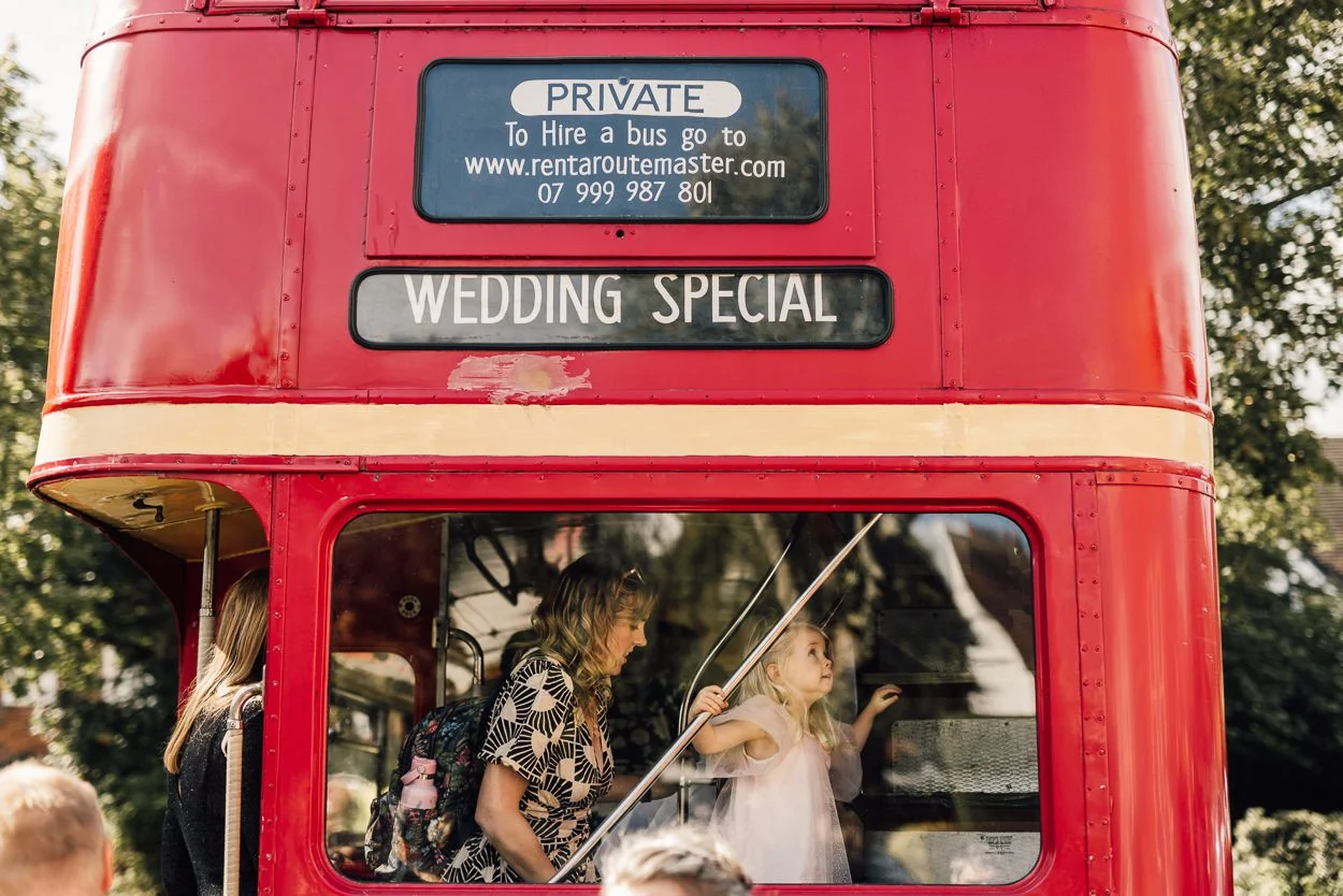 Guests board wedding bus