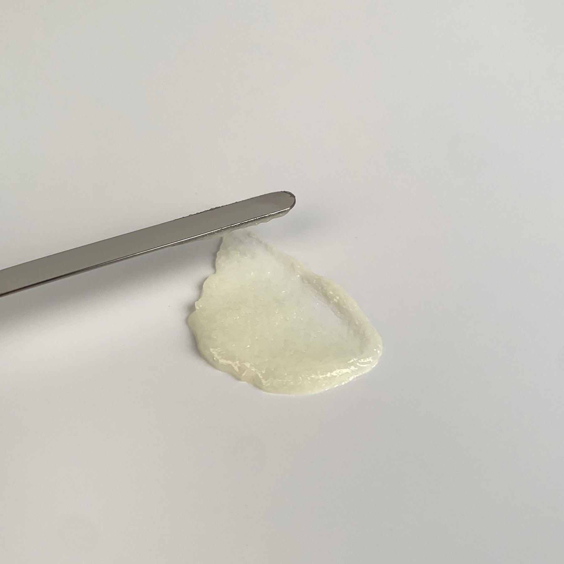 Lightweight fluid serum texture of Medipair Sun Clear Serum showing transparent residue-free application