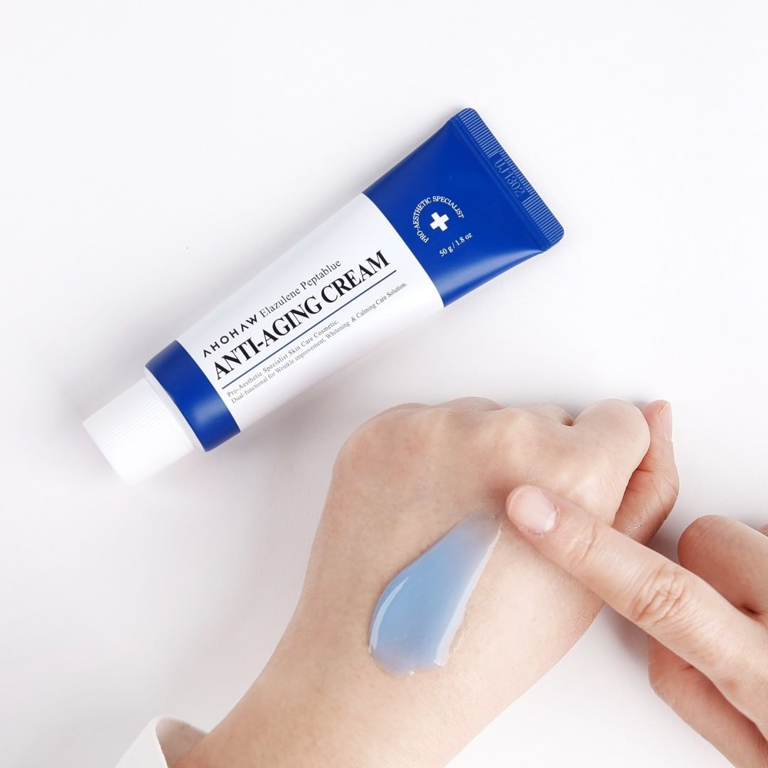 Applying Ahohaw Elazulene Peptablue Moisturizer to smooth fine lines and firm skin
