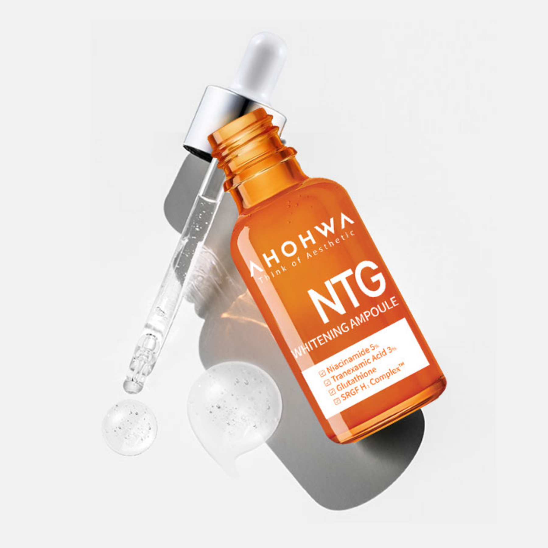 Close-up of dropper dispensing liquid Ahohaw NTG Whitening Ampoule with Niacinamide and Tranexamic Acid
