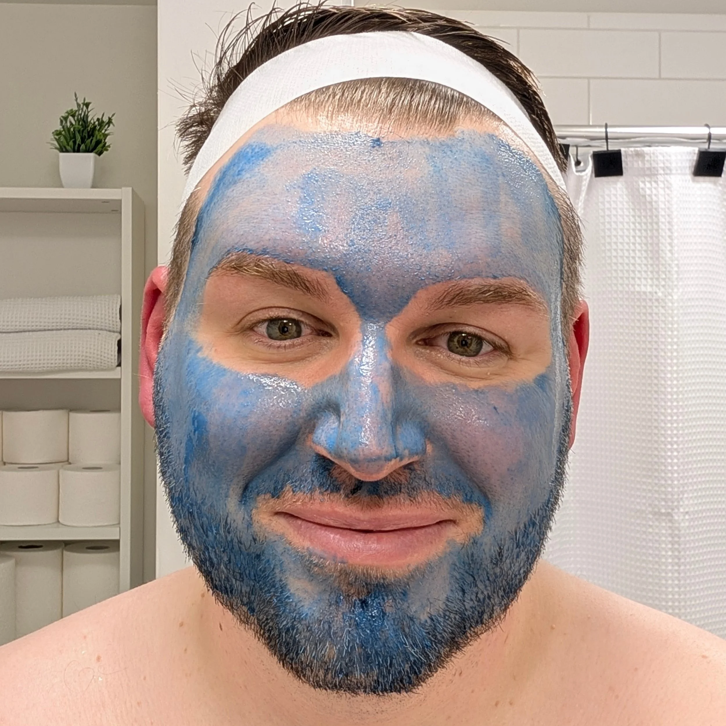 Male client undergoing a professional K-Beauty blue spirulina facial peel for skin resurfacing and pore clarification.