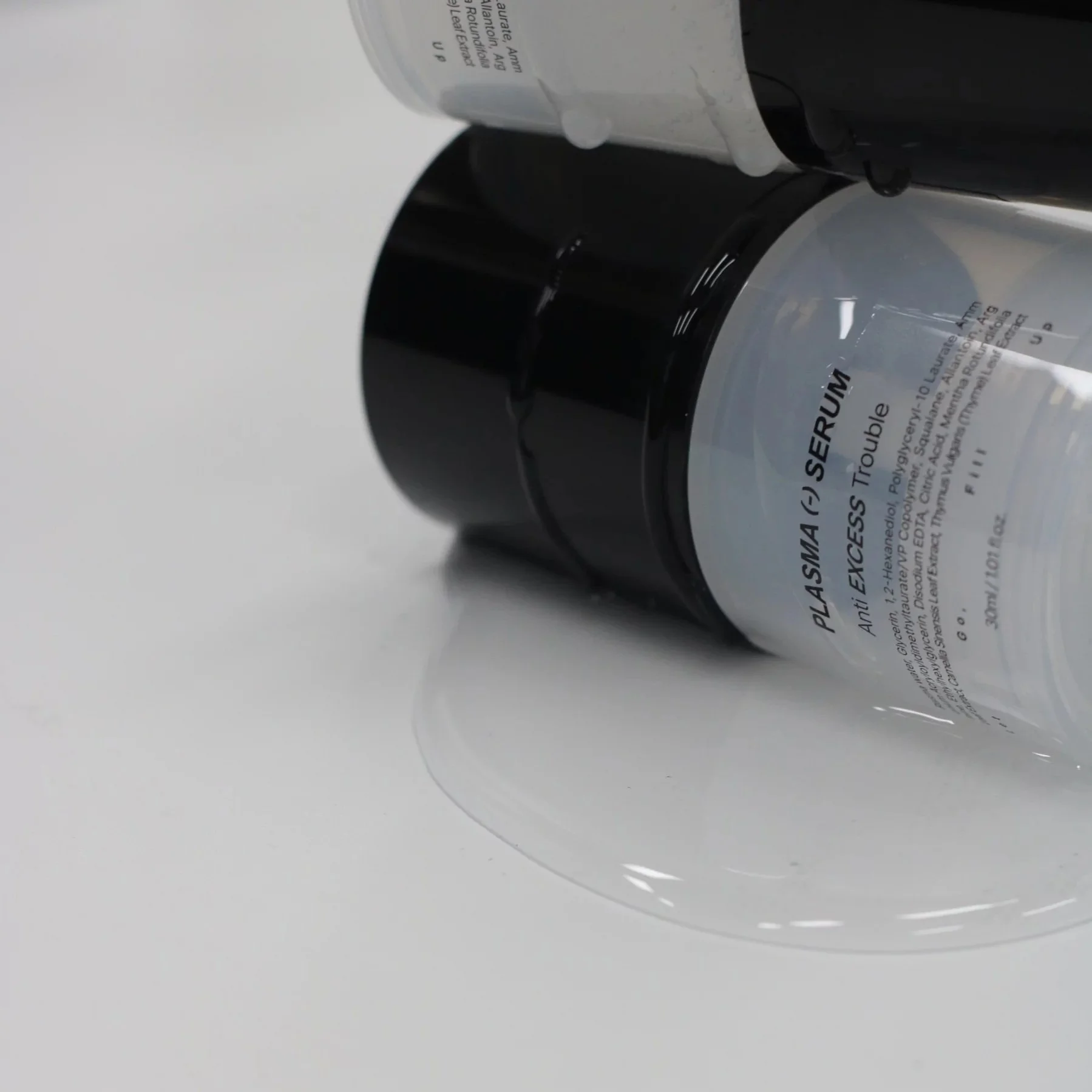 Medipair's Plasma Serum bottle on it's side with product leaking out and showing it's watery texture