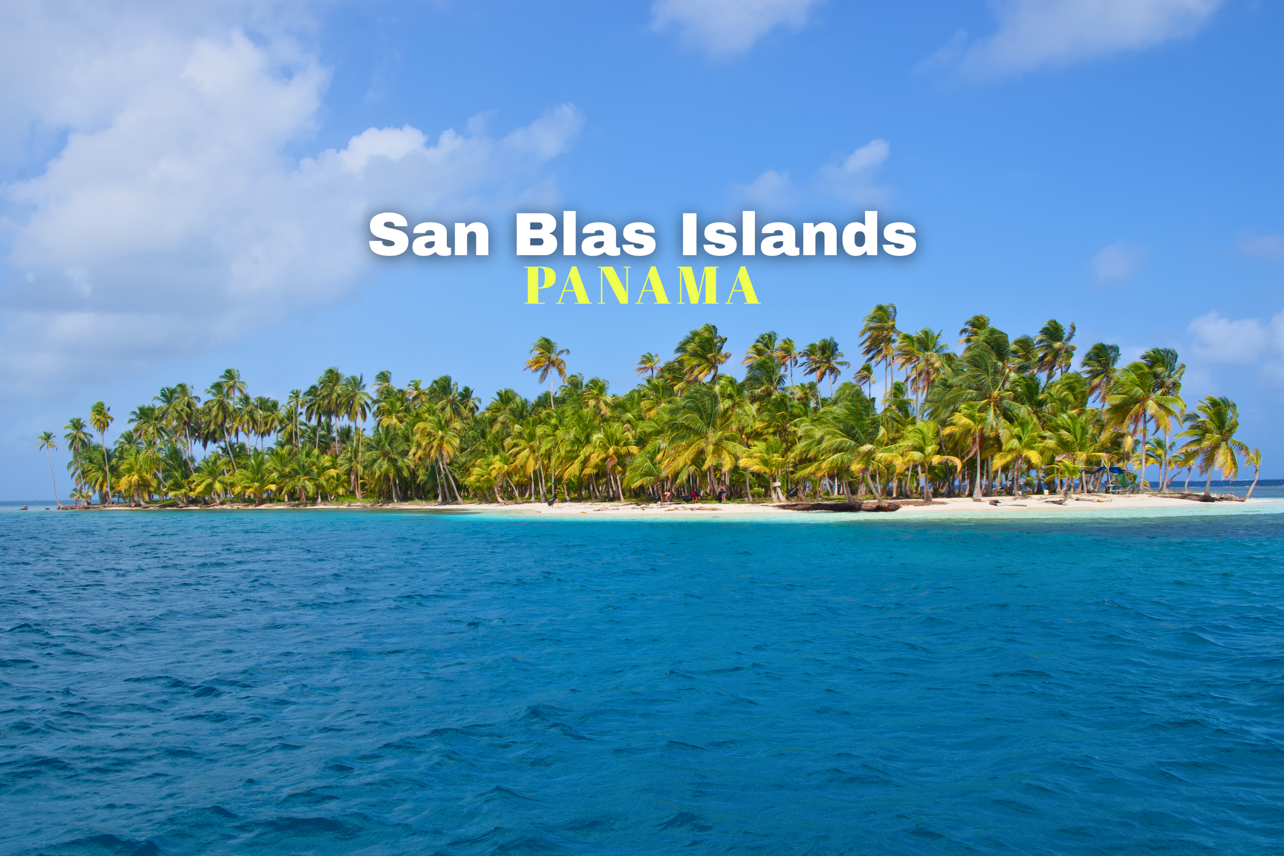 Tropical island with dense palm trees, sandy beach, and clear blue ocean in San Blas Islands, Panama.