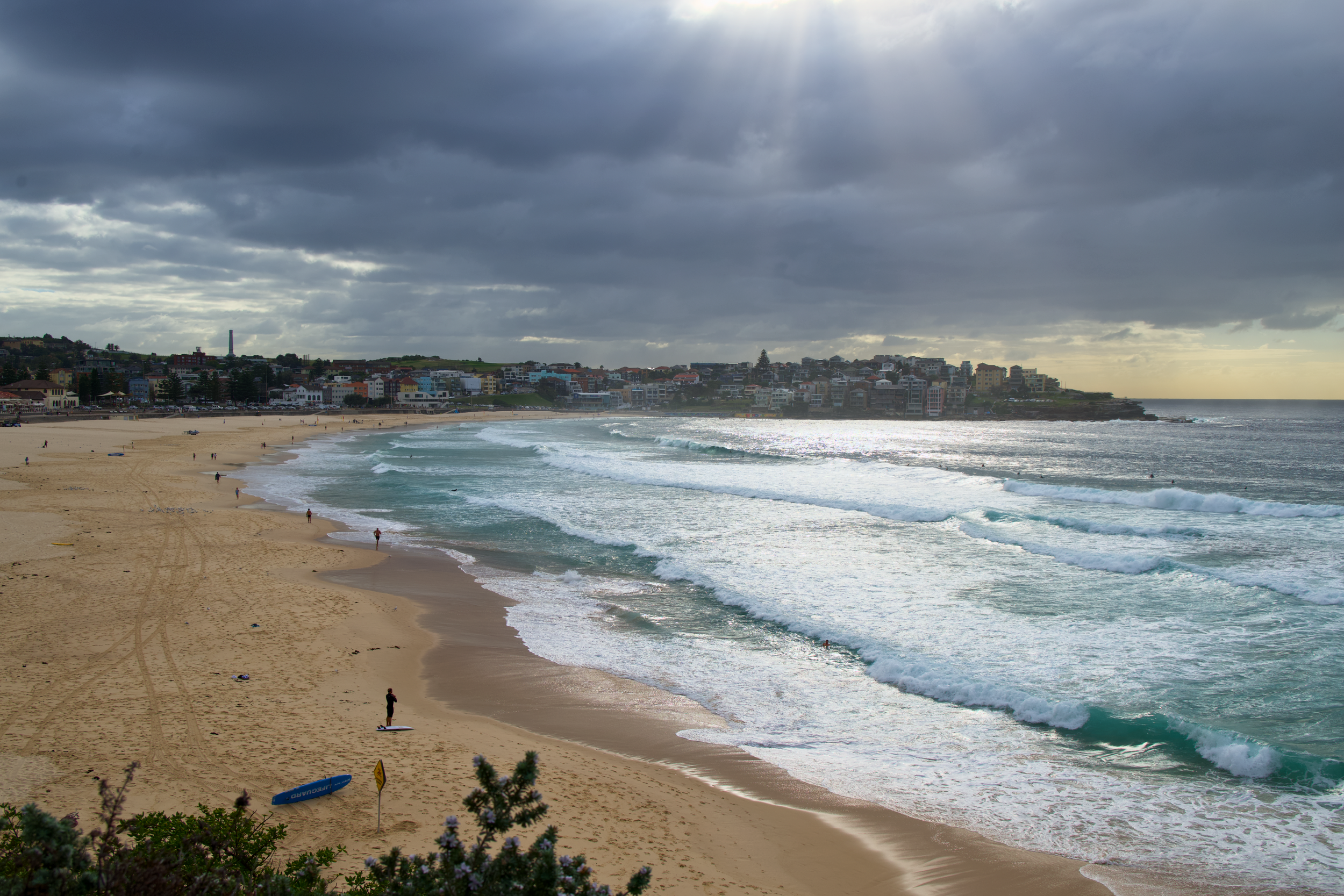 Bondi Beach in Sydney, Australia at sunrise with surfers or swimmers enjoying the morning