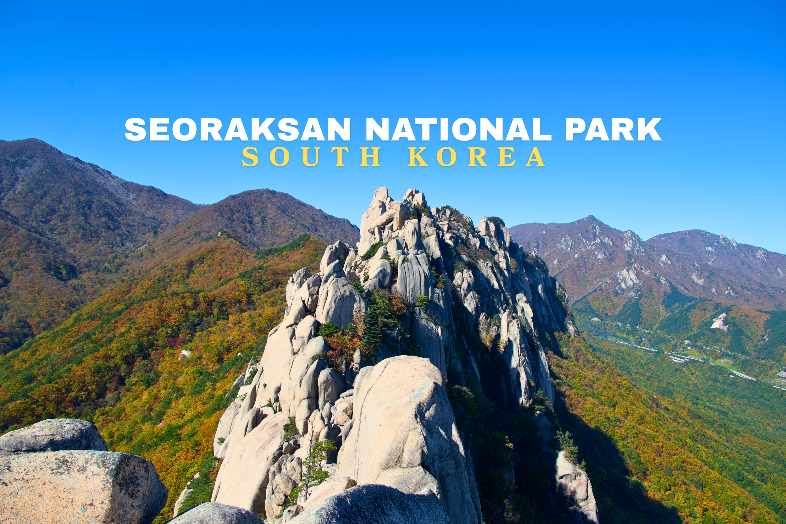 Scenic view of granite rock formations and lush green mountains in Seoraksan National Park, South Korea, under a clear blue sky.