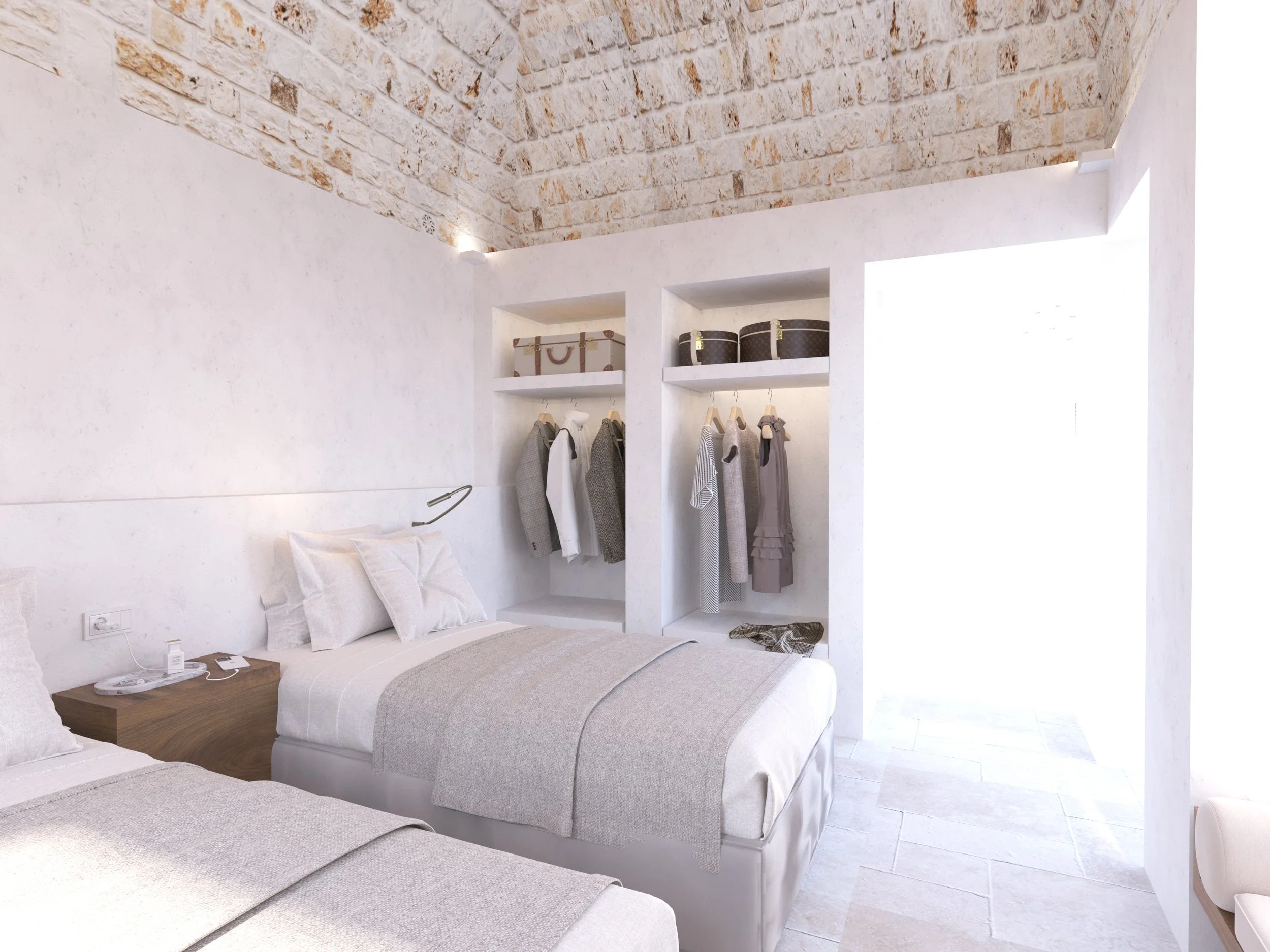 Modern bedroom with stone ceiling, two beds with beige bedding, open closet with clothes hanging, and a wooden bedside table.