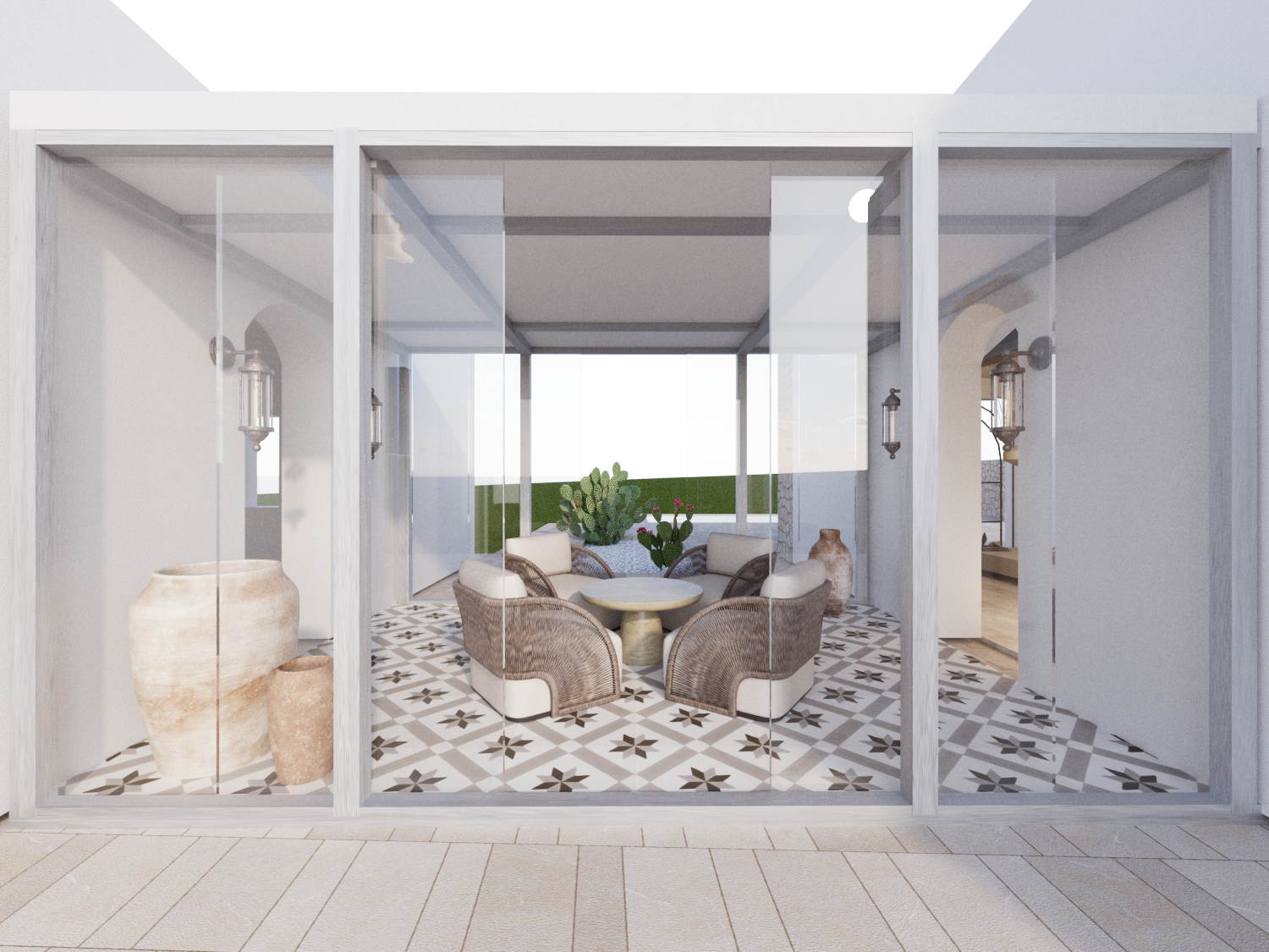 Interior view of a sunroom with glass walls, patterned tile flooring, wicker and fabric armchairs around a round table, potted plants including cactus, and decorative vases.