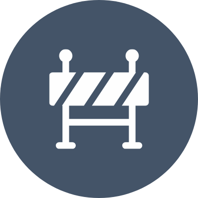 A construction barrier with two warning poles and striped panels.