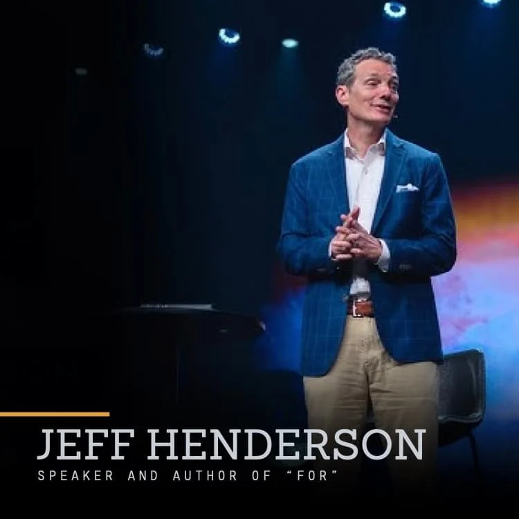 Jeff Henderson, speaker and author of 'For,' standing on stage in a blue blazer, white shirt, and khaki pants, with stage lights overhead.
